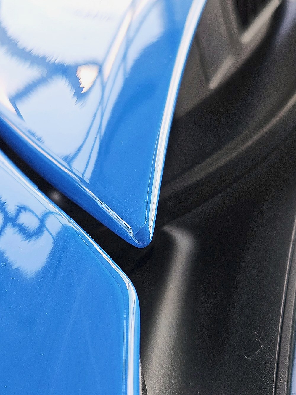 Close-up of glossy blue paint with clear protection film