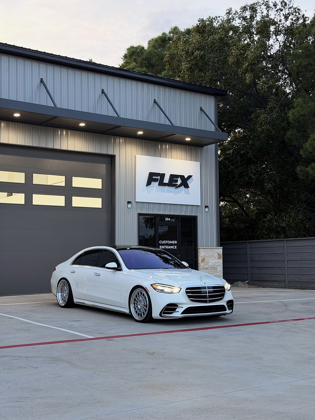 The FLEX Auto Styling shop front in Prosper with a white Mercedes parked out front