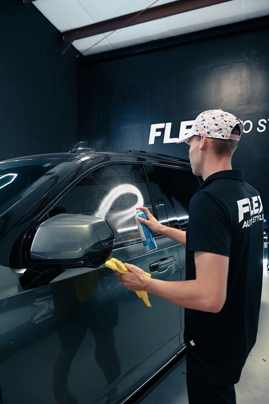 FLEX installer polishing freshly tinted car window